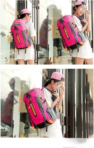 Detail view of pink and grey outdoor backpack with yellow zippers and side mesh pockets