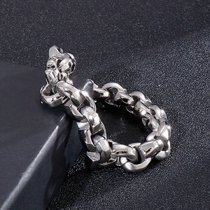 Macro detail of silver skull chain ring with polished heavy metal texture on dark base
