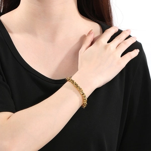 Close-up of a gold Byzantine chain bracelet worn on a wrist for a high-end fashion look