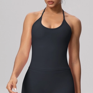 Detail of black halter neck yoga top with cross-back straps and built-in pads