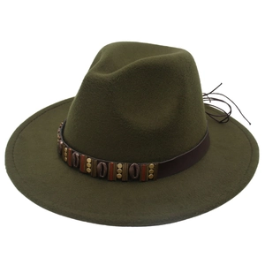 Detail of dark green fedora hat featuring brown leather band with metallic shell accents
