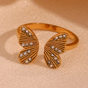 Macro detail of 18K gold-plated butterfly ring with sparkling zircon stones