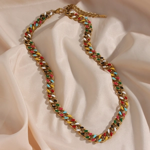 Detail of 14K gold Cuban link chain with colorful enamel accents on silk background