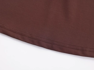 Detail of the high-quality double-needle stitching on dark brown yoga top fabric