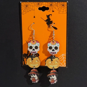 Detail of wooden Halloween earrings featuring skull, pumpkin, and ghost charms on a card