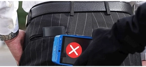 Slim black leather RFID blocking wallet shown in pocket with security sensor alert