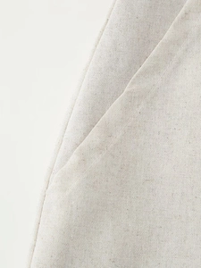 Macro view of the beige linen blend fabric texture and professional stitching details