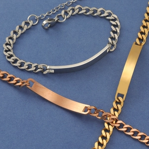 Detailed view of Cuban chain ID bracelets in silver, gold, and rose gold finishes