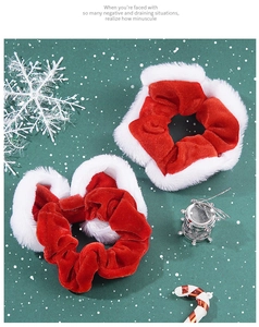 Detail of red velvet Christmas scrunchies with white plush trim and festive ornaments