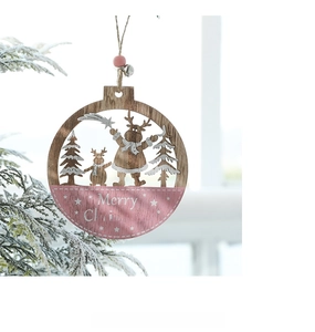 Close-up of pink wooden Christmas reindeer ornament with Merry Christmas text on a tree branch