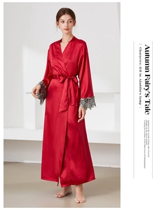 Detail of red silk robe showing elegant grey lace cuffs and glossy satin texture
