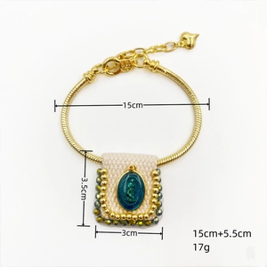 Detailed view of religious Virgin Mary charm bracelet with gold snake chain and dimensions