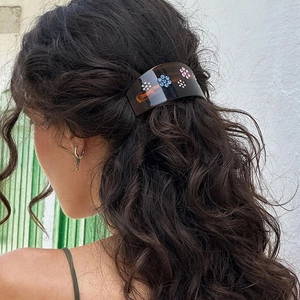 French vintage amber heart hair clip with colorful rhinestone flowers on dark curly hair