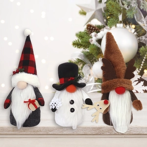 Three festive Christmas gnomes in classic plaid and snowman designs on a wooden table