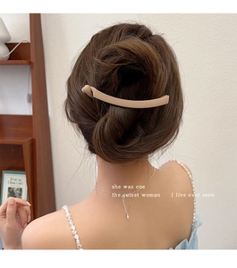 Close-up of matte banana hair clip in apricot on model with elegant low ponytail