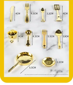 Miniature golden kitchenware set showing detailed tiny spoons, forks, and frying pans