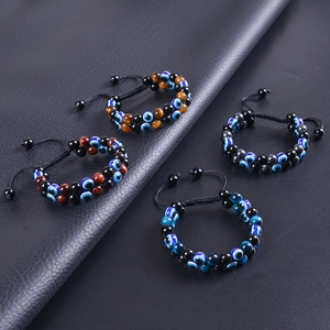 Macro view of evil eye beaded bracelets with tiger eye stones and braided cords