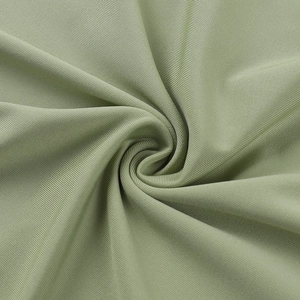 Detailed macro view of grass green ribbed knit fabric with vertical texture and soft drape
