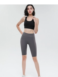 Detailed view of high-waisted gray fitness shorts featuring breathable mesh texture and seams