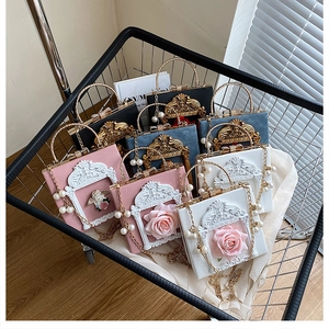 Baroque embossed angel flower handbags with pearl chains in a stylish wire basket