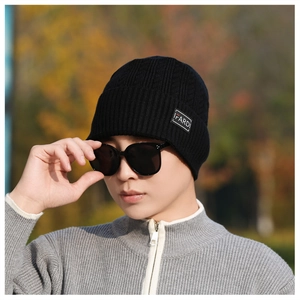 Close-up of black ribbed knit beanie featuring the IFARD brand woven label on the cuff