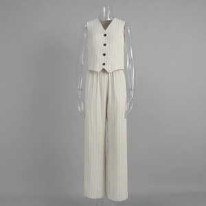 Detail of V-neck pinstripe vest and matching elastic straight trousers in beige cotton linen