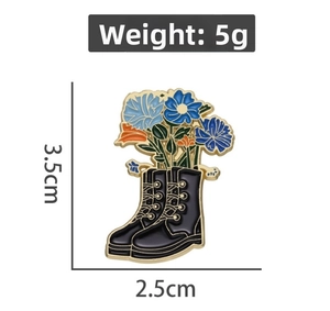 Detail of floral enamel brooch in boot shape with dimensions 3.5cm by 2.5cm