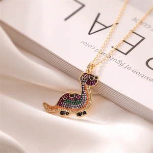 Detailed close-up of a gold-plated dinosaur pendant featuring colorful pavé zircon stones
