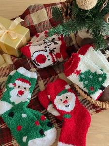 Close-up of thick coral fleece Christmas socks with festive patterns for winter warmth