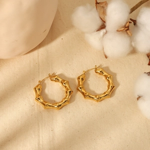 Chic 18K gold-plated chunky hoop earrings with bamboo texture on beige linen background