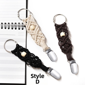Macro detail of hand-woven cotton hat clips in various colors with wooden beads