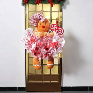 Christmas gingerbread man wreath with red and white candy cane ribbons for door decor