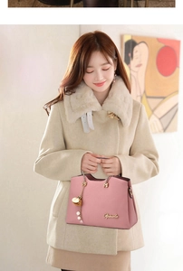 Detail of pink lychee leather handbag with golden metal handles and pearl bag charm