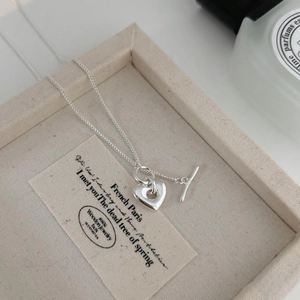 Detailed macro of S925 sterling silver heart pendant with stylish T-bar OT clasp closure
