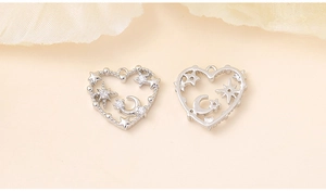 Detailed macro view of silver heart charms with zircon moon and star inlay designs