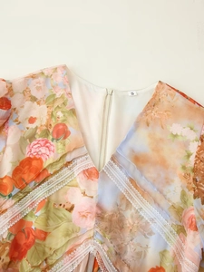 Detail shot of V-neckline with white lace trim and vintage floral print on autumn dress