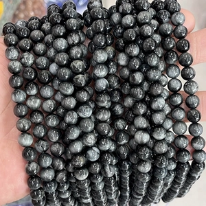 Macro shot of polished black hawk eye stone round beads for DIY jewelry making