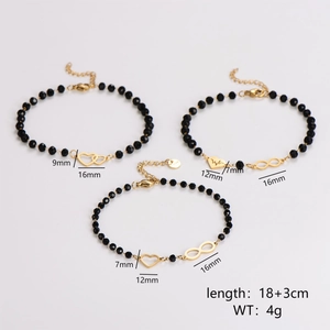 Three-piece black beaded bracelet set with gold heart and infinity charms