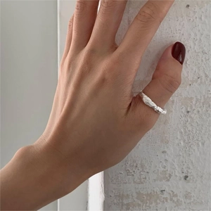 Detail of twisted 925 sterling silver thumb ring with a minimalist spiral texture