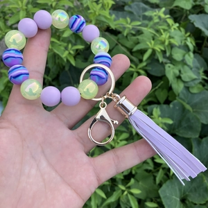 Detail of colorful silicone bead bracelet with purple PU tassel and gold lobster clasp
