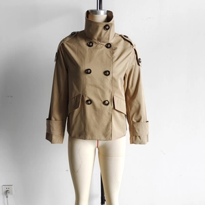 Detail view of khaki double-breasted short trench coat with epaulettes and classic collar