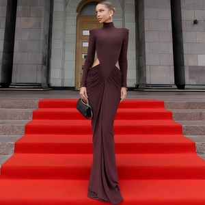 Elegant deep red long sleeve dress with waist cut-out and pleated details in full view