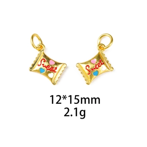 Macro detail of gold-plated sweet candy bag charm with red lettering and heart motifs