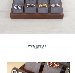 Macro detail of walnut jewelry display stand with pearl and gemstone earrings