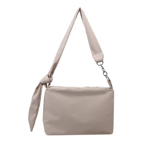Minimalist beige nylon crossbody bag with wide knot strap and silver metal hardware