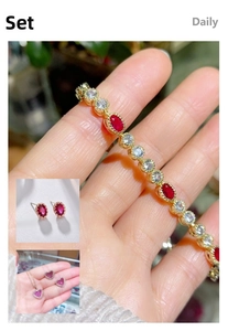 Close-up of gold-plated bracelet featuring ruby gemstones and white zircon accents