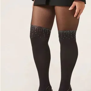 Black faux thigh-high tights with sparkling rhinestone trim and sheer panel design