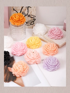 Detailed close-up of colorful peony flower candles showing realistic petal textures