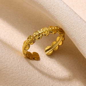 Detailed macro view of an adjustable gold open ring with leaf-like wave texture details