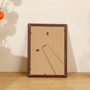 Nordic dark walnut photo frame back view with folding stand and dual hanging hooks